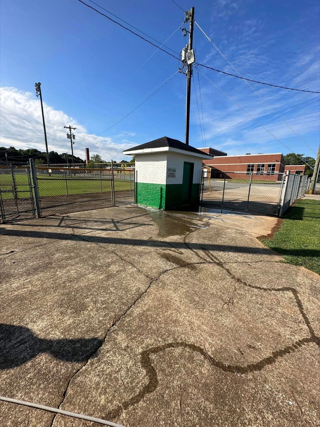 Pressure-cleaned commercial concrete in progress
